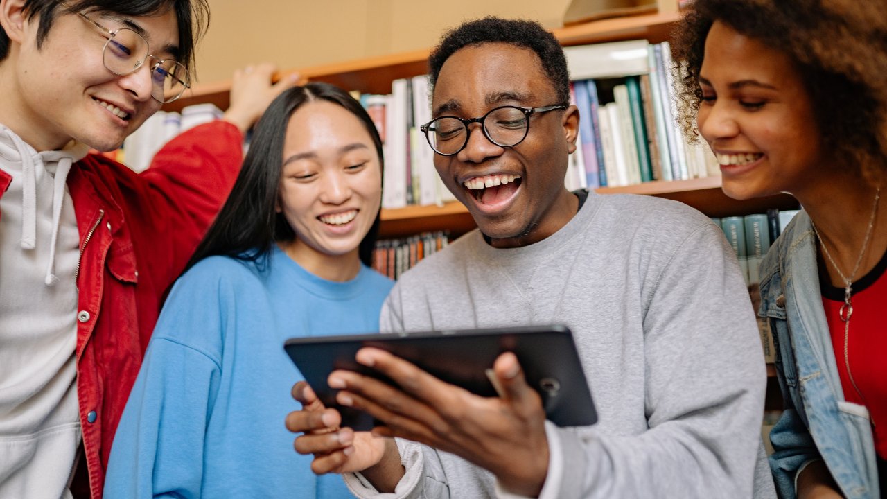 Group of learners working together on a tablet