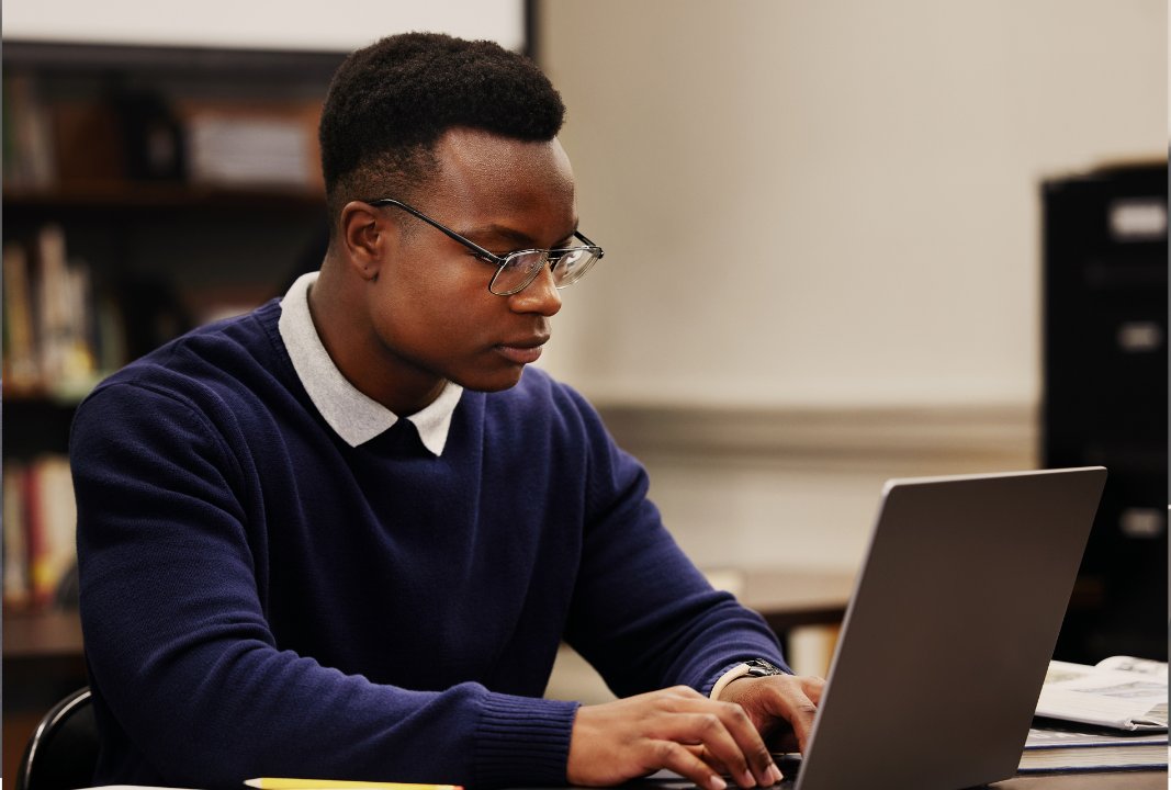Learner focused on a laptop during a training session